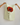Towel with a red poppy print  held by two hands against a white background